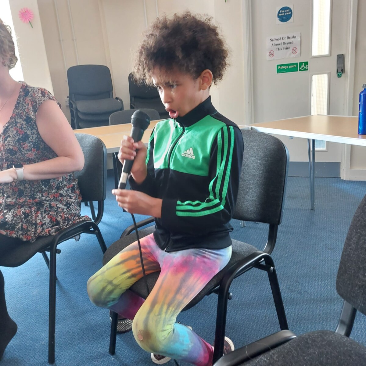 Young child sings into microphone